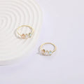 Geometric birthstone ring with horse eye shaped tricolor zircon stones in gold colour