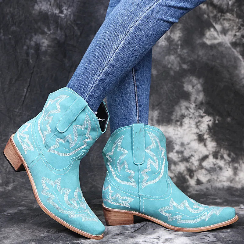 Blue women's cowboy boots with embroidery on the shaft and a low wedge heel.