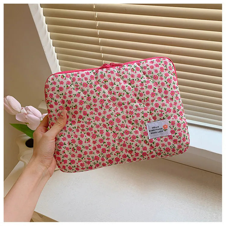 Floral print cloth laptop bag in green flower, pink floral, red flower, and red heart designs, showing three size options.
