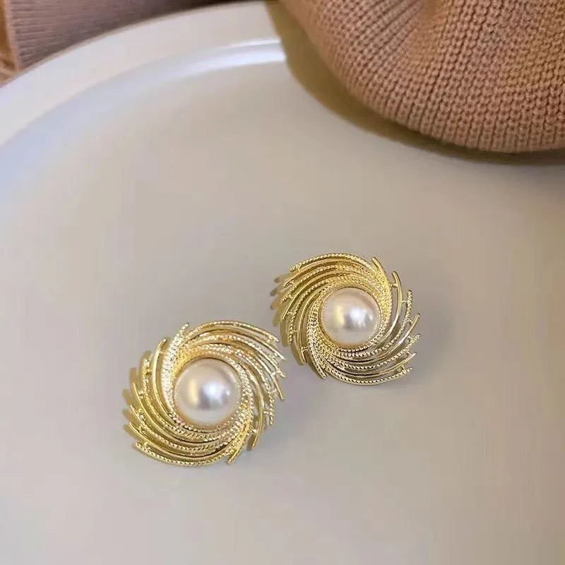 Flower shaped vintage earrings with exaggerated pearl centres and irregular design elements