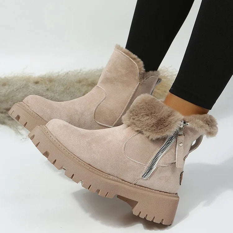 Women's black snow boots with foldable plush tube, suede upper, and rubber sole on winter pavement