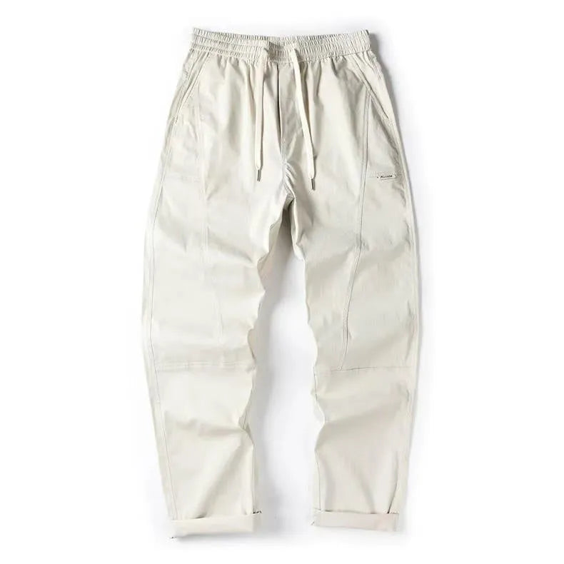 Cotton wide-leg casual trousers in Milky White hanging on a hanger, showing relaxed fit and full length.