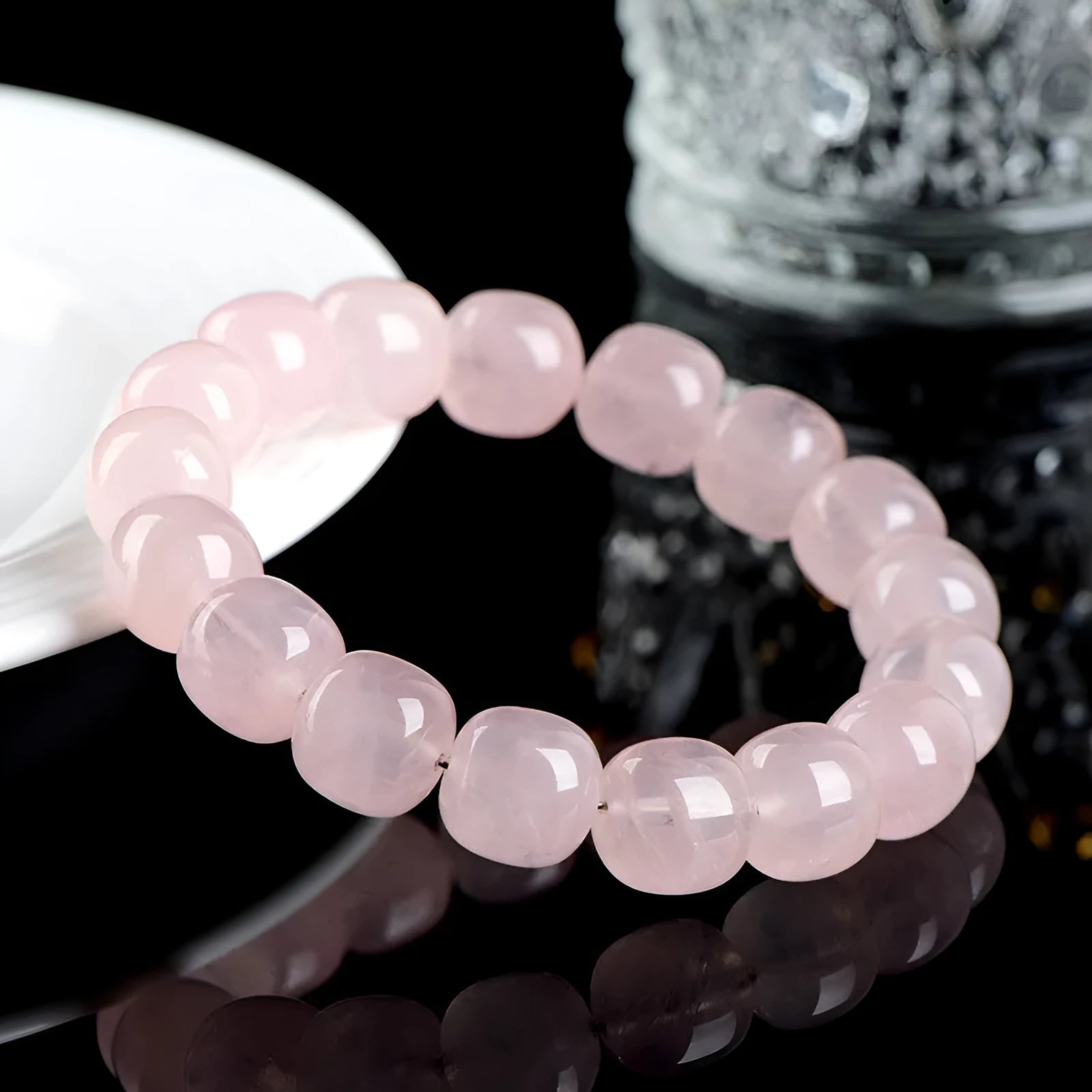 Pink crystal barrel bead bracelet with 11-12mm geometric beads on natural background