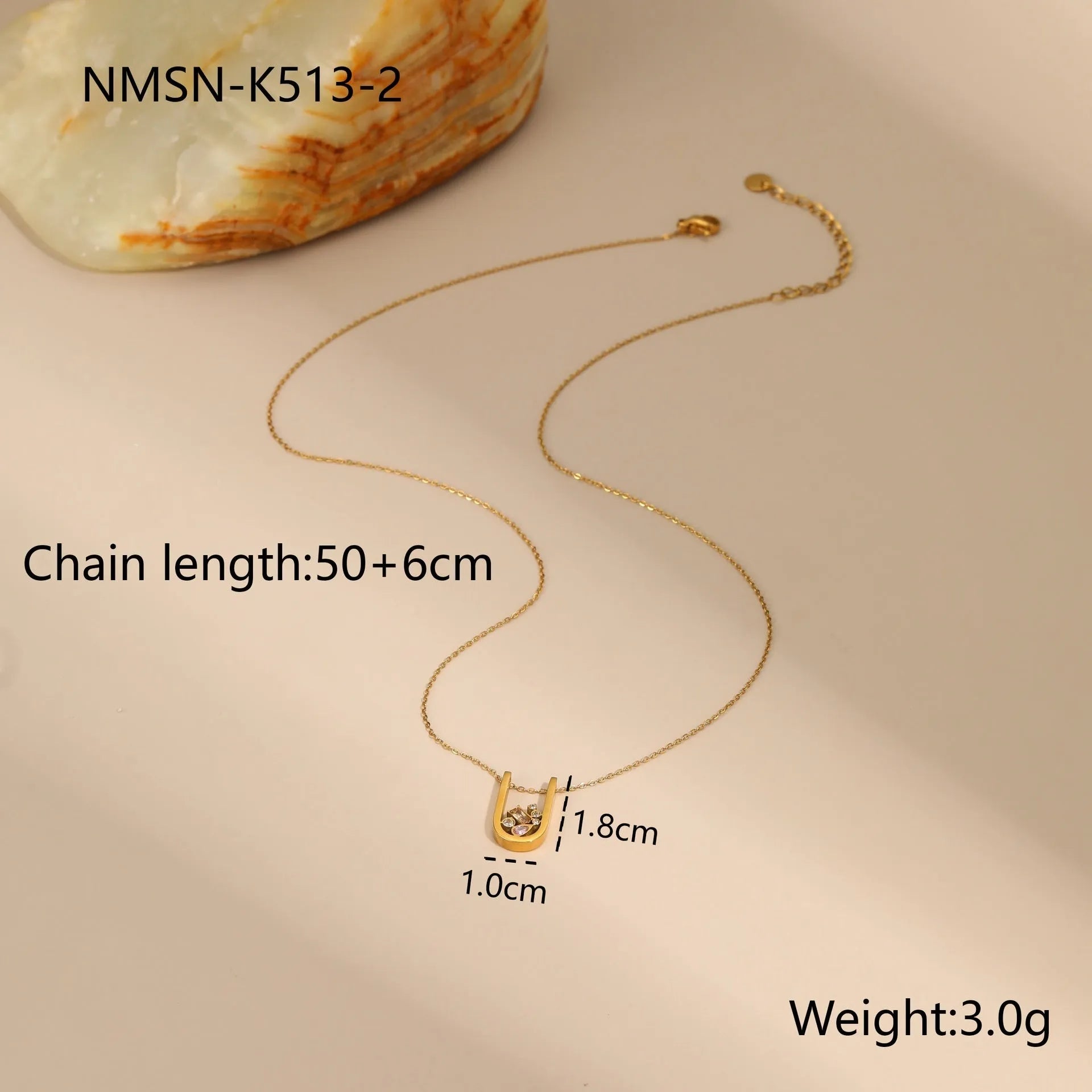 Geometric gold-plated jewellery set with necklace, earrings, and ring on display