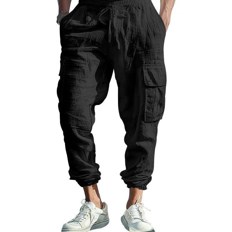 Man wearing khaki linen casual trousers with ankle-tied legs and multiple pockets.