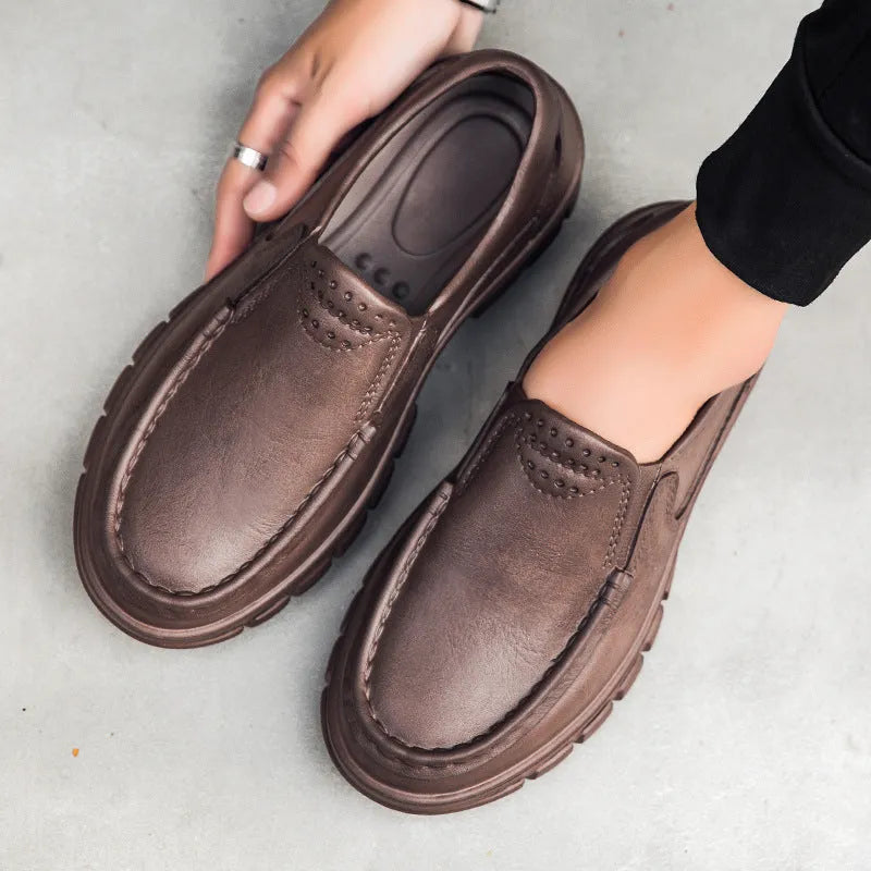 Men's black slip-on work shoes with a mid-top waterproof artificial leather upper and platform sole.