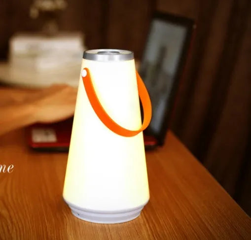 White rechargeable LED bedside lantern with USB cable, showing compact columnar design
