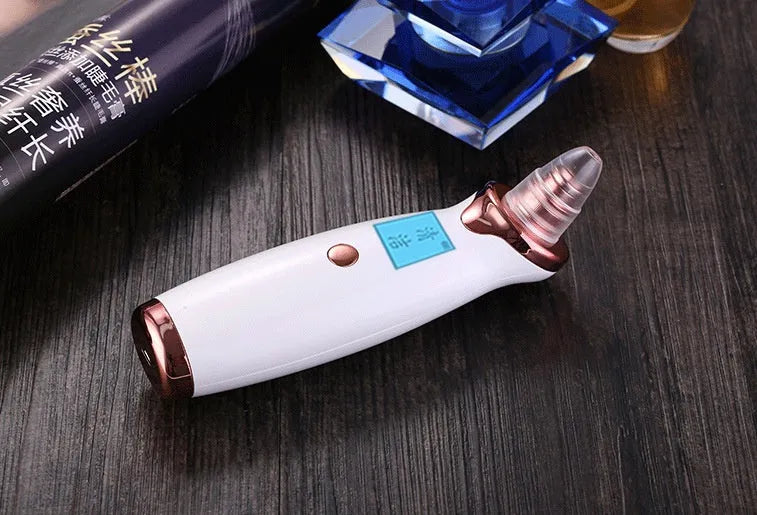 Blackhead remover pore cleaner with LCD display in ivory white on a clean surface