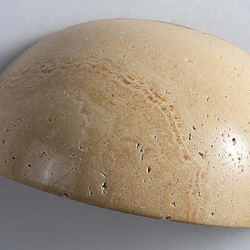 Retro marble semicircle wall lamp with adjustable LED light on a stone wall