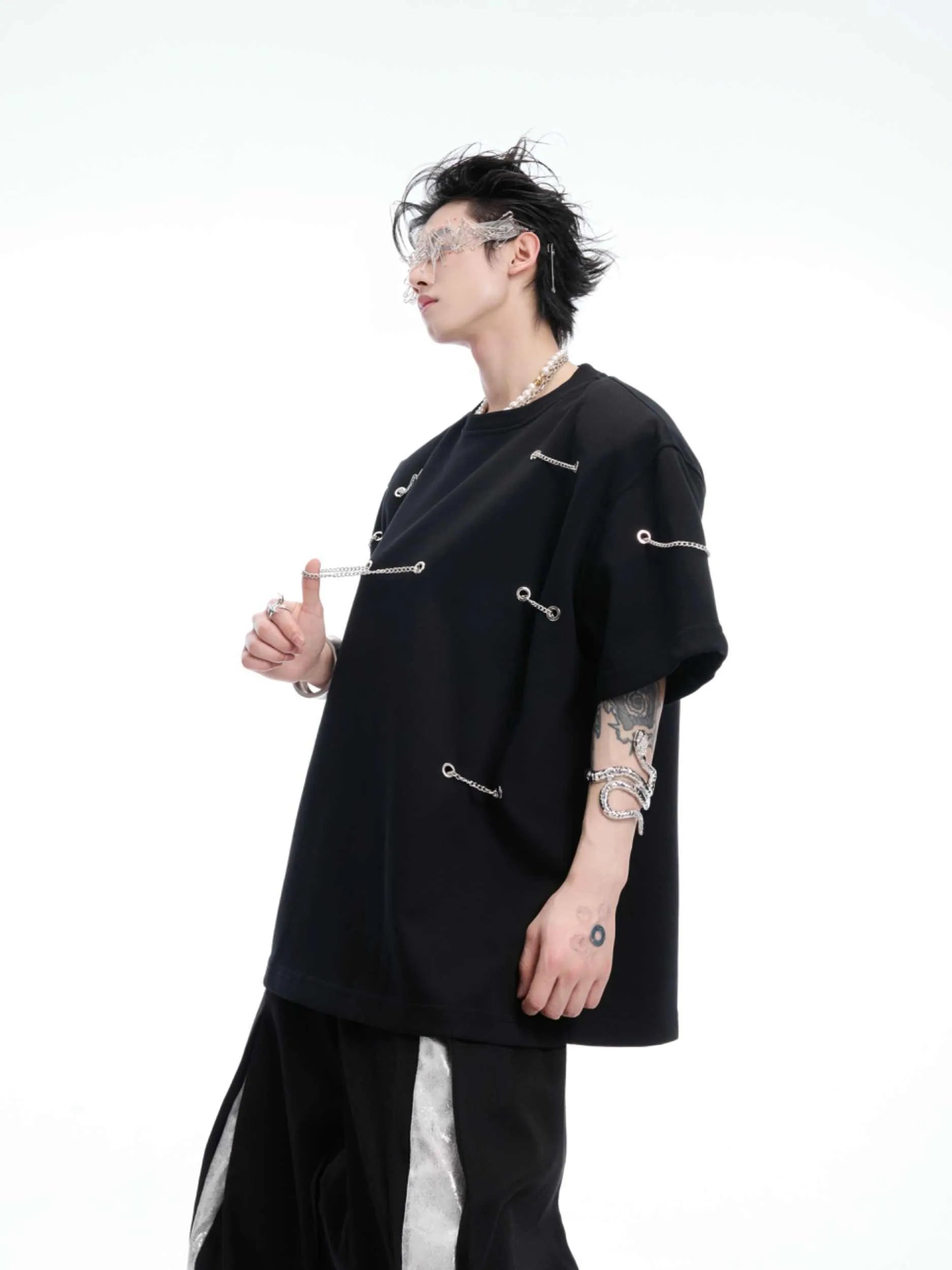 Black cotton blend T-shirt with metal chain detail on padded shoulders, short sleeves, round neck, front view