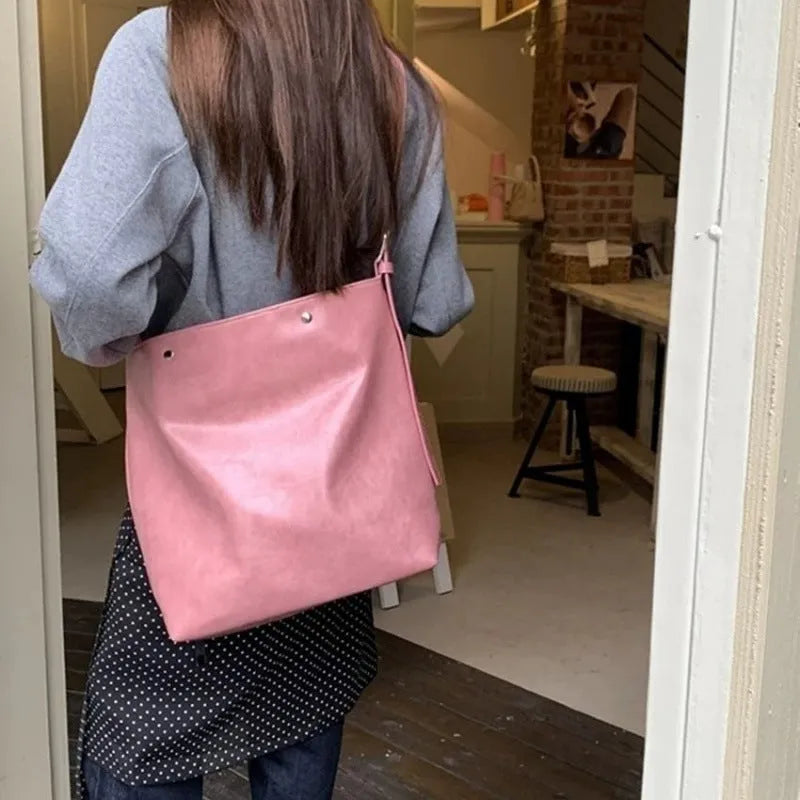 Pink corduroy one-shoulder commuter bag with dimensions 39cm by 32cm