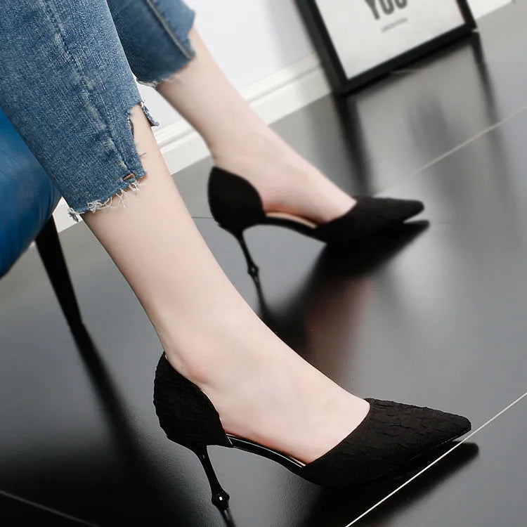 Women's black pointed toe stiletto high heels with PU leather upper on a plain background.