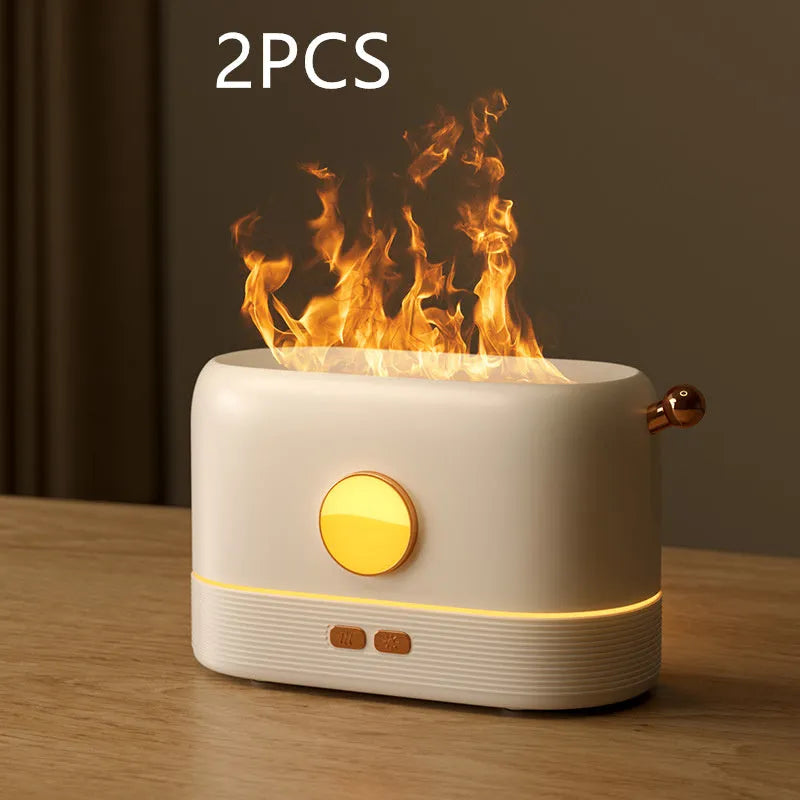 Black USB desktop humidifier with decorative orange flame effect and water tank on a wooden desk.