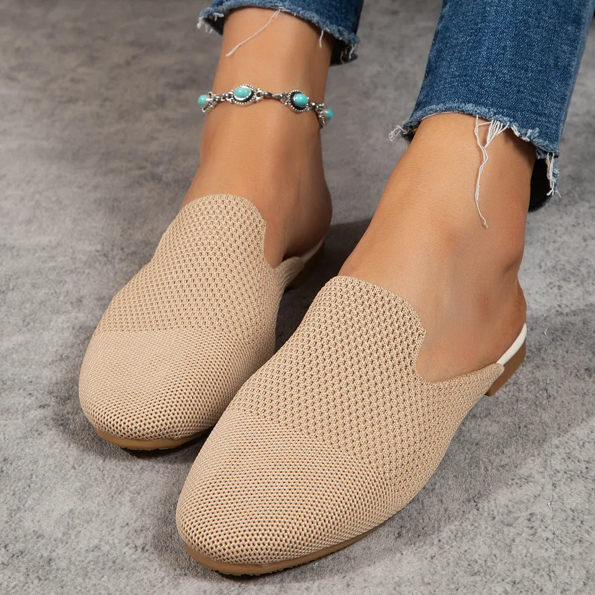 Apricot coloured mesh slip-on sandals with a round toe and flat rubber sole.