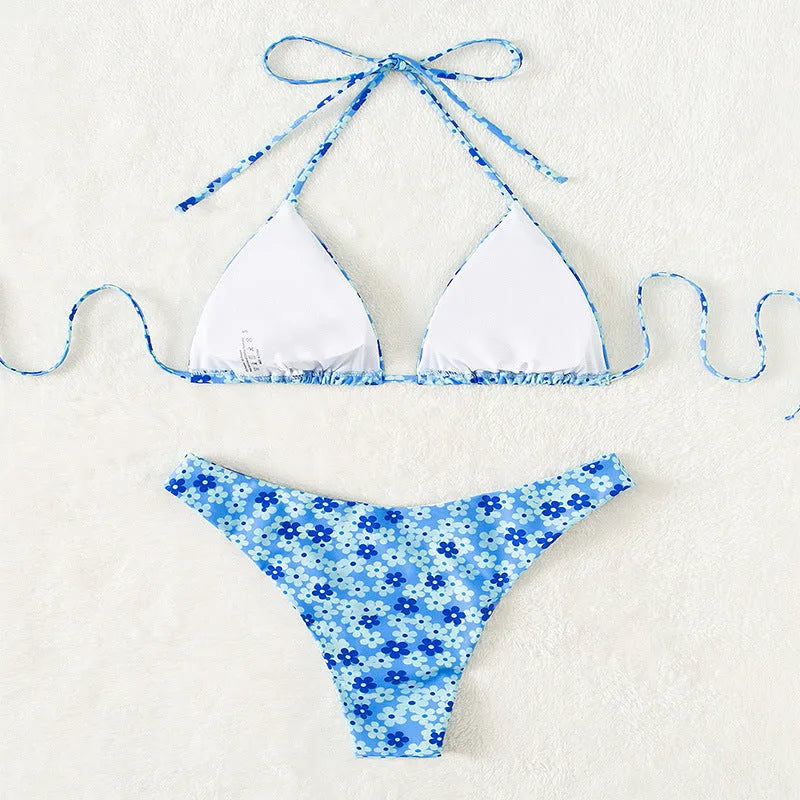 Women's blue printed swimsuit with lace-up front and split shorts on white background
