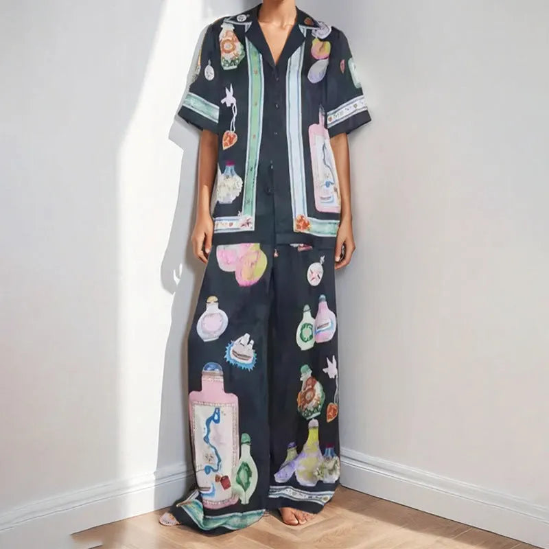 Black women's casual set with cartoon print, showing cardigan and matching trousers