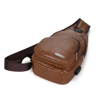 USB charging chest bag in black PU leather with embossed pattern showing front zipper and USB port