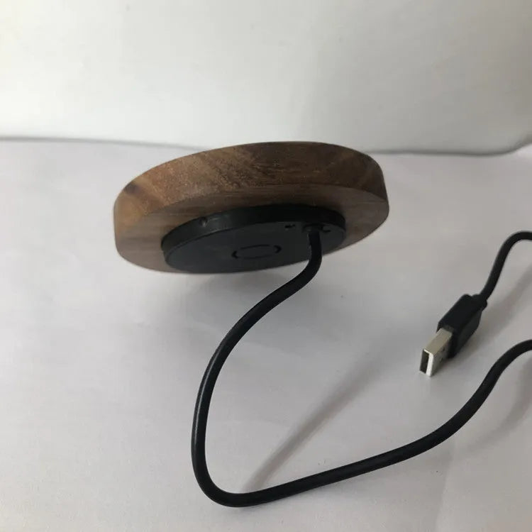 Round 60mm hidden wireless phone charger for installation in furniture.
