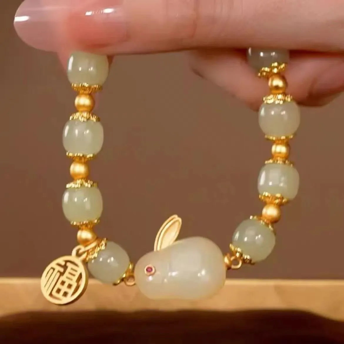 Women's green lucky jade hare bracelet with black elasticated cord