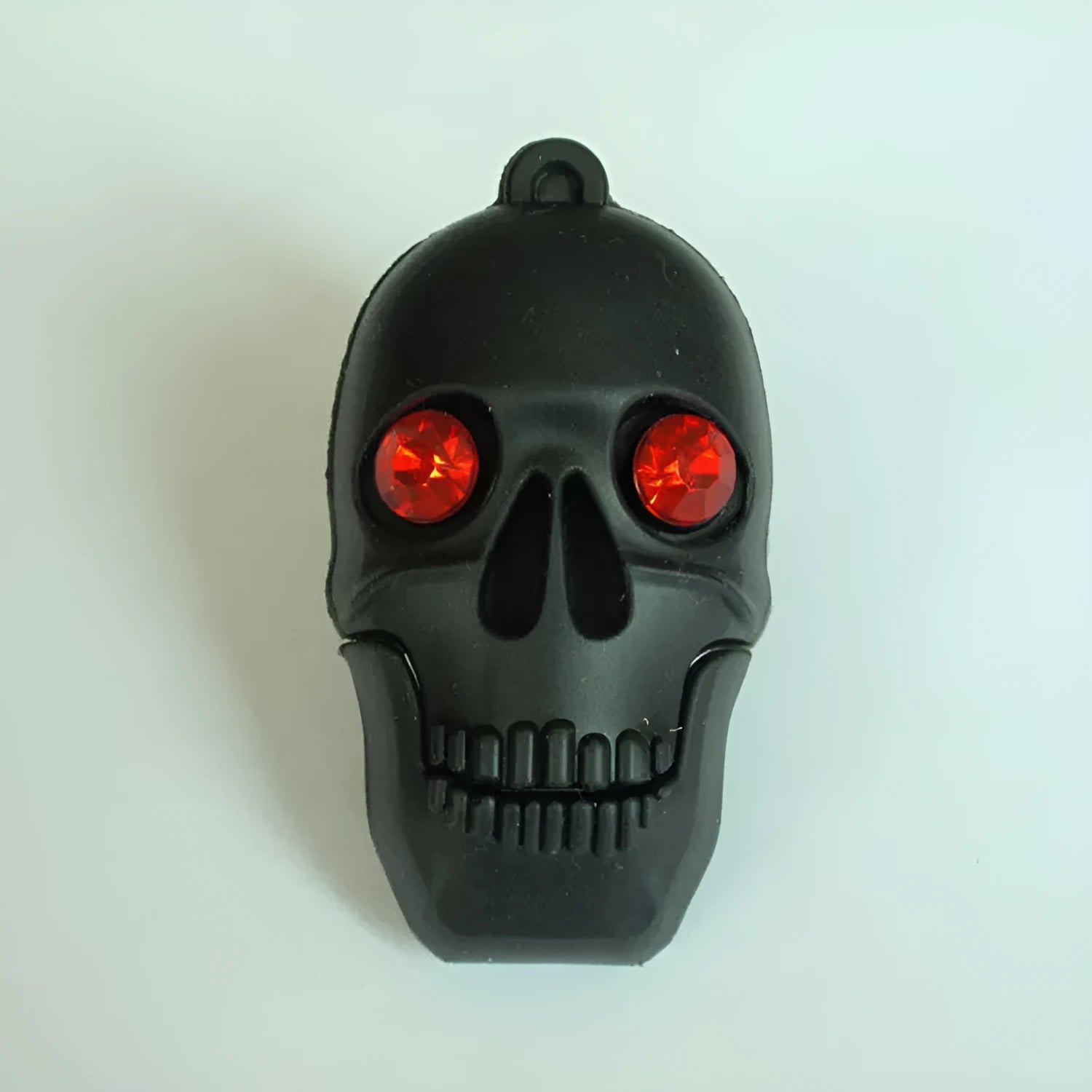 Skull-shaped USB flash drive on a small chain with PVC shell and USB 3.0 connector.