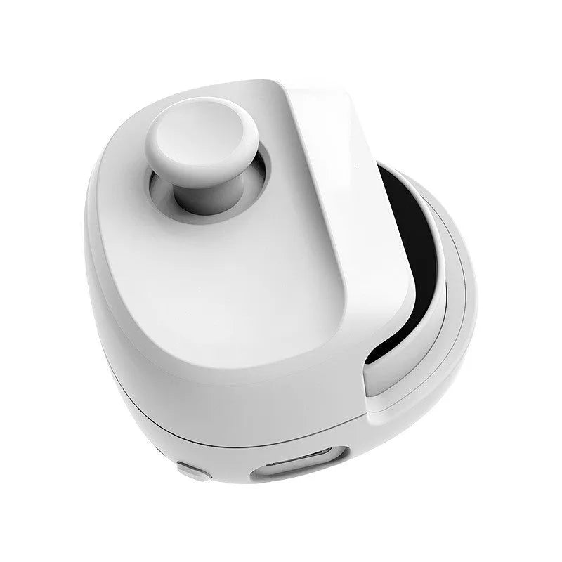 Black and white USB gaming stick controller on a desk, showing compact square design.