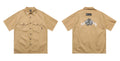 Men's loose black half-sleeve cotton shirt with embroidered chest pocket detail