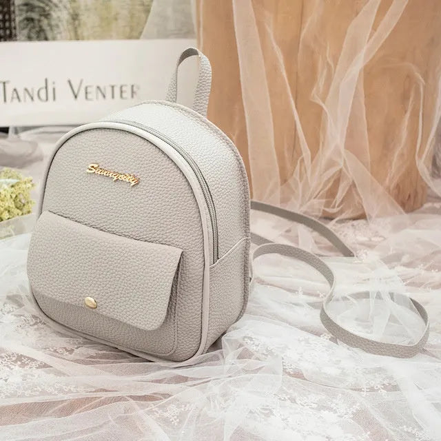 Women's small black PU backpack purse with letter design and zipper closure