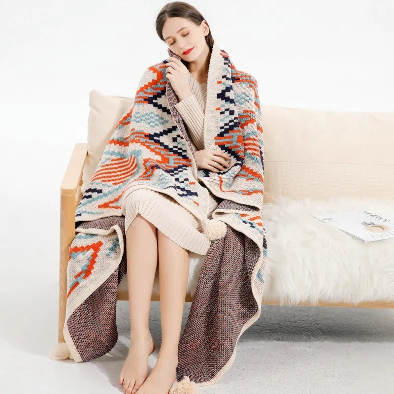 Acrylic sofa blanket with tassel fringe in geometric pattern, showing 130 cm width measurement