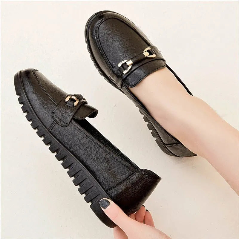 Black soft leather casual pumps with a round toe, flat rubber sole, and shallow slip-on design.