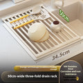 Milky white foldable stainless steel kitchen draining rack shown over a sink.