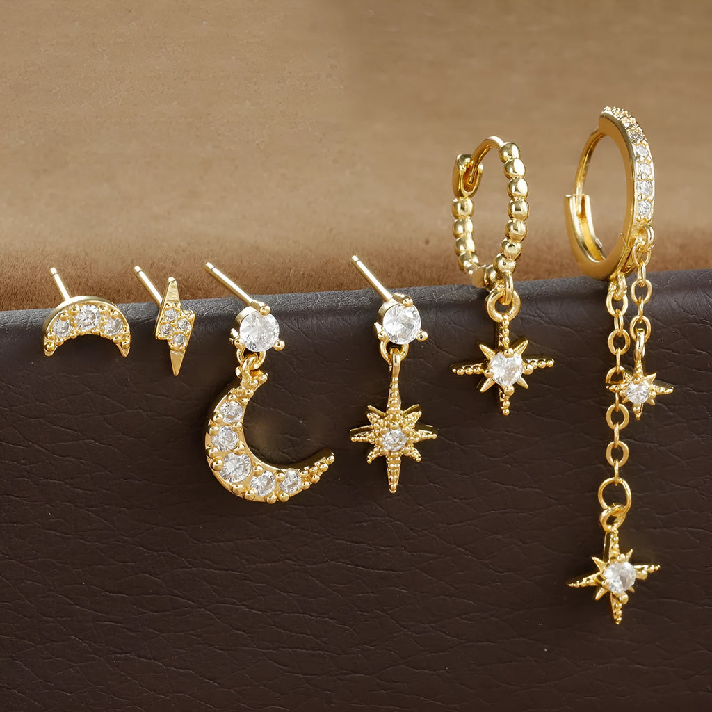 XINGX set of six gold electroplated chain tassel earrings with zircon studs on display