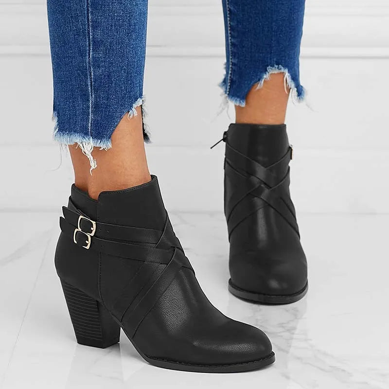 Men's black short ankle boots with side zip, belt buckle, and a 7cm heel.