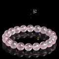 Pink crystal bracelet with round polished beads in natural starlight style showing size options from 6mm to 22mm diameter