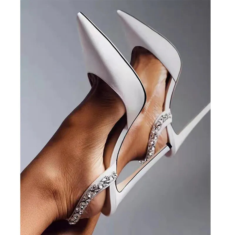 Rhinestone embellished pointed toe high heel sandals in glossy patent leather.