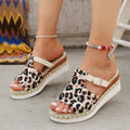 Leopard print women's platform sandals with a wedge heel and fish mouth toe in beige, on a white background.