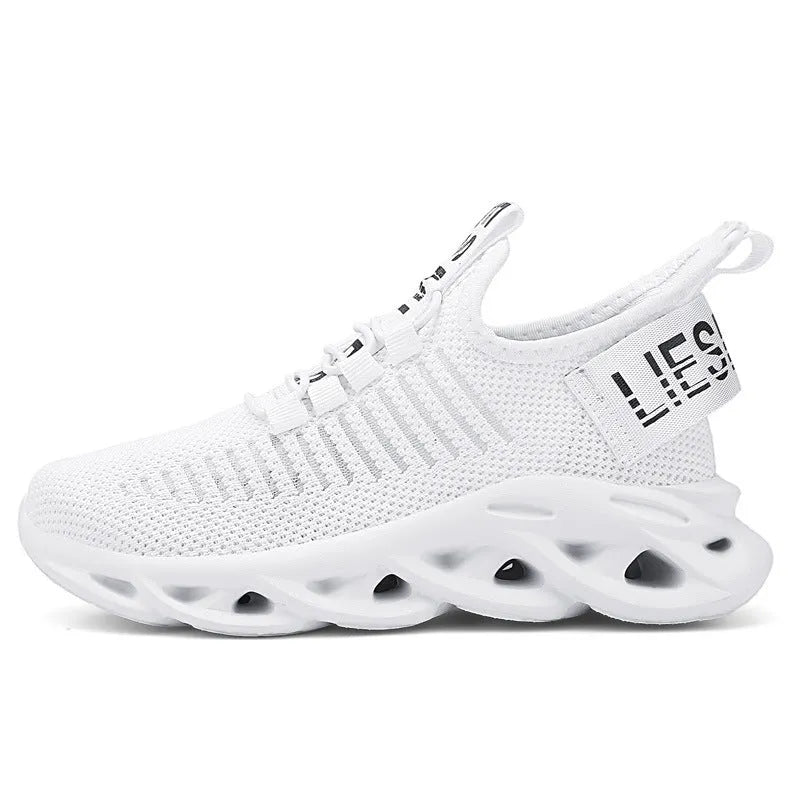 Child wearing trendy black coconut sneakers with Velcro strap and fabric upper.