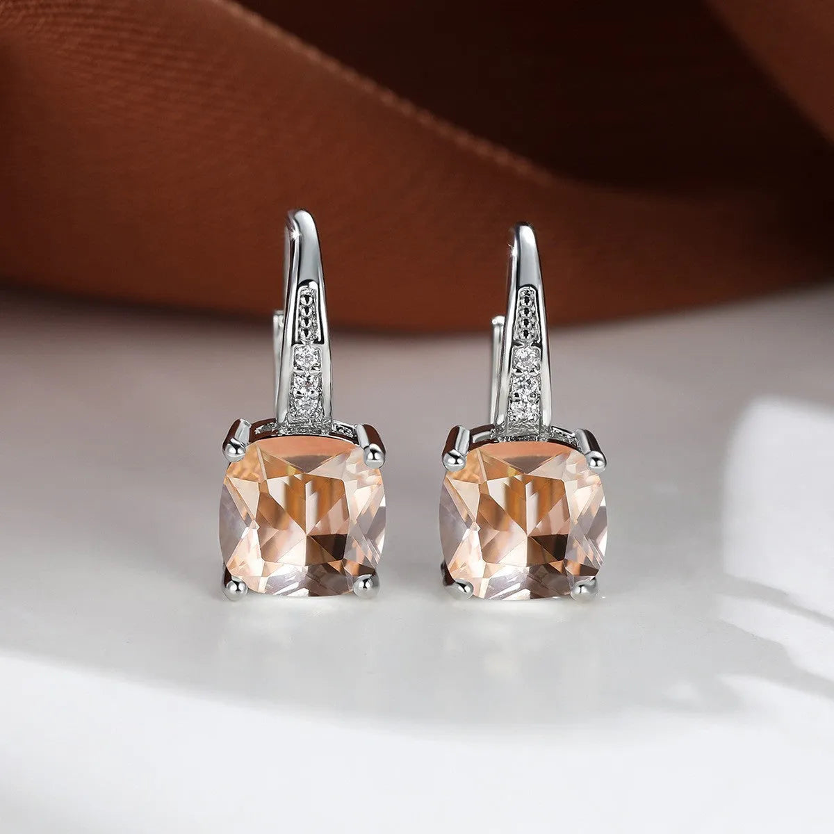 Square geometric ear hook studs with a round zircon stone, shown in a gold electroplated finish.