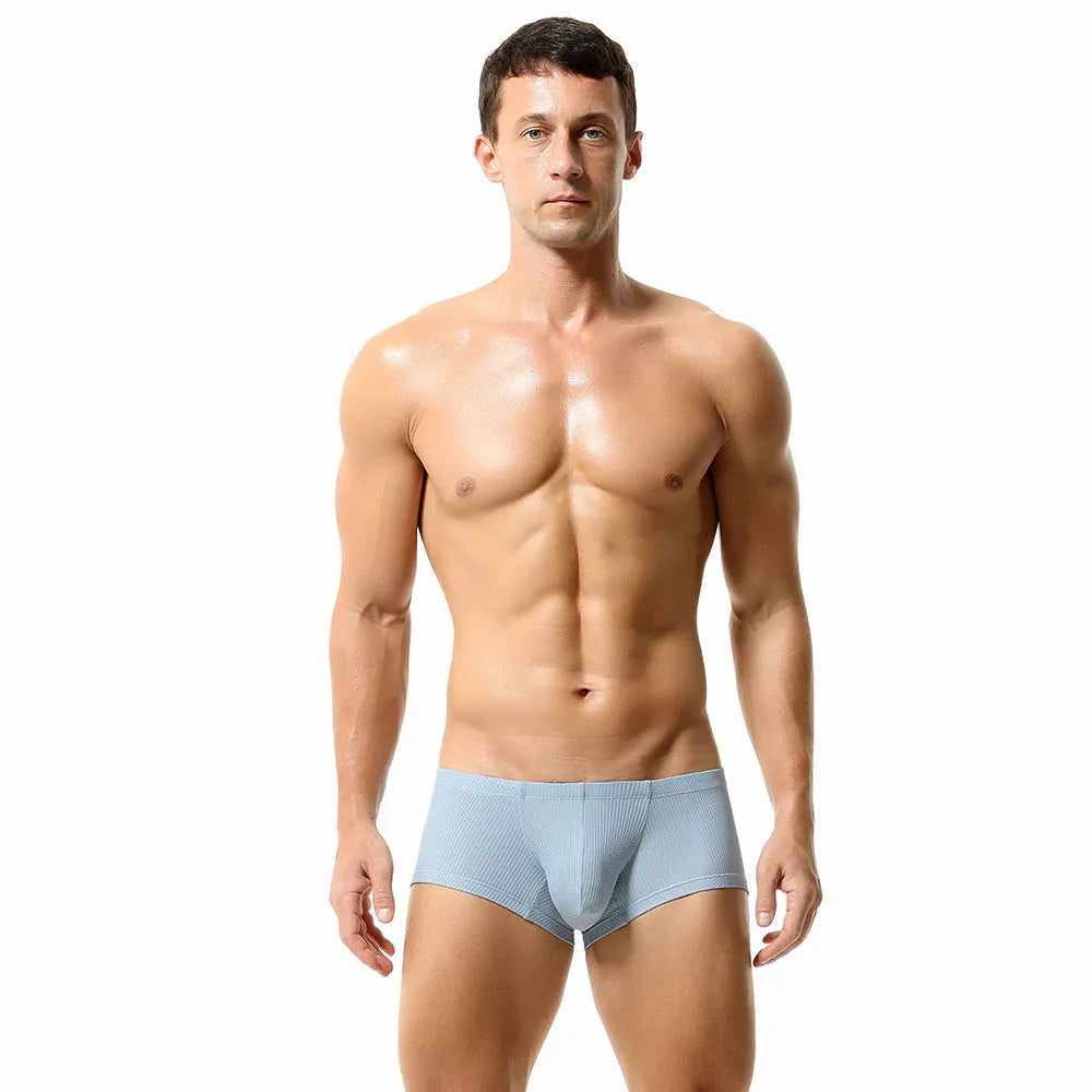 Men's solid colour low-waist nylon boxer shorts on a white background.