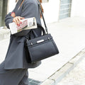 Genuine leather small square shoulder bag in almond green colour showing internal compartments