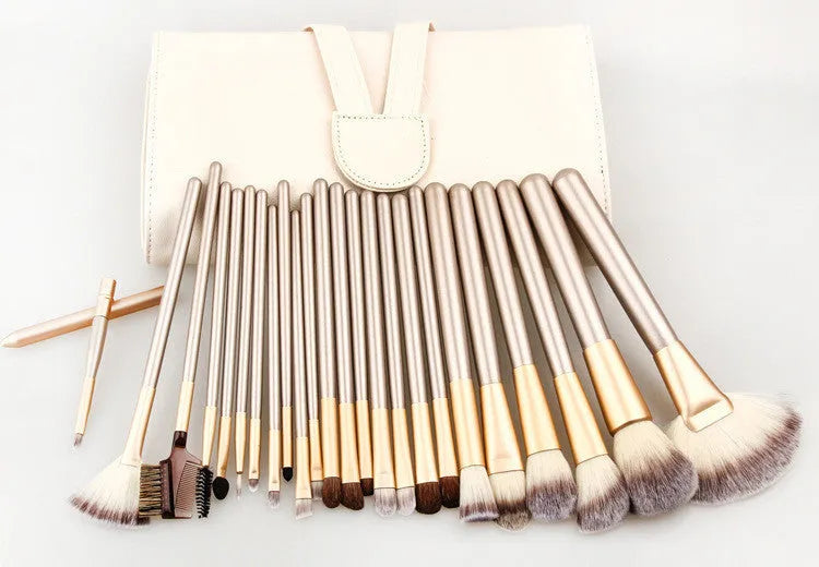 Champagne white synthetic fibre makeup brush set with wooden handles and aluminium ferrules on flat surface