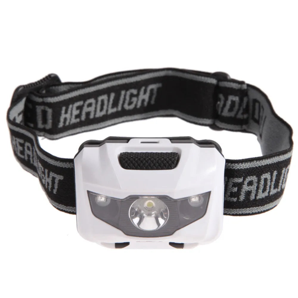 Black head torch with white and red LEDs mounted on an adjustable head strap for outdoor use.