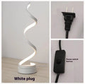 Minimalist black LED table lamp with aluminium shade and tri-colour dimming on wooden bedside table