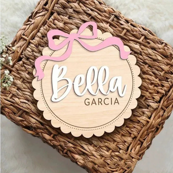 A square wooden ornament personalised with a baby's name for nursery decoration or photo prop.