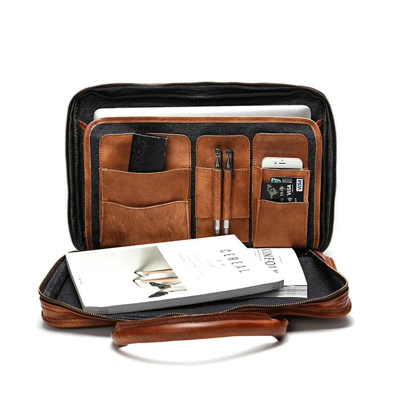 Black vintage leather men's briefcase open to show internal laptop pocket, camera pocket, and document organisation.