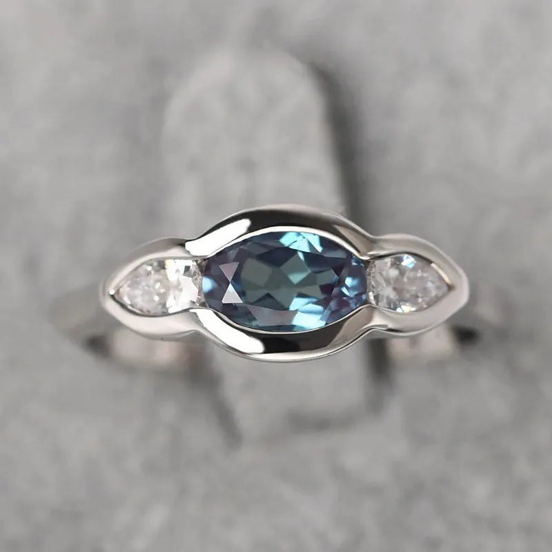 Women's geometric ellipse ring with inlaid zircon stones in white gold tone finish on finger