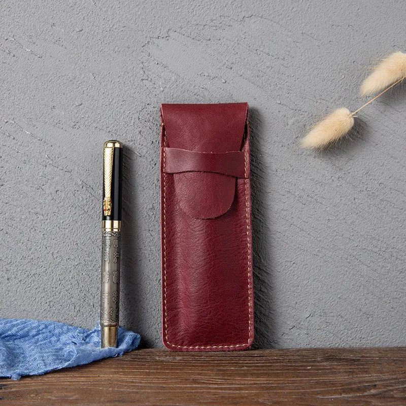 Brown leather pencil case with zip opening on a plain background