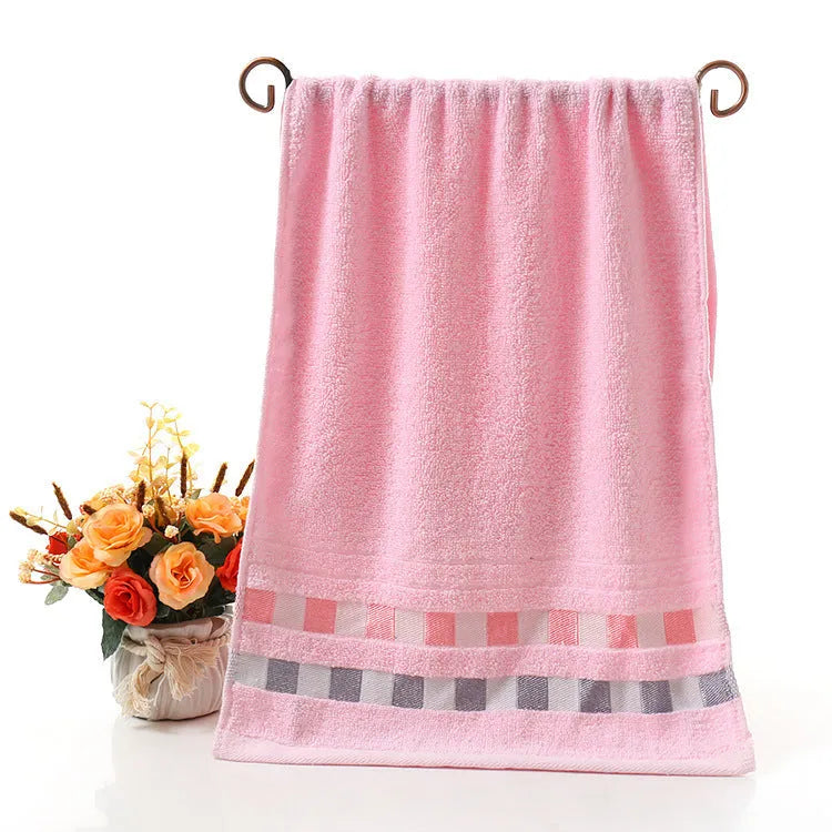 Cotton face towel 73x33cm in blue pink yellow patterns on hanger