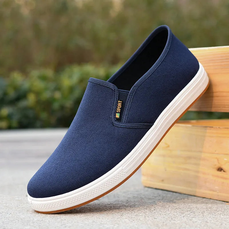 Men's black and blue canvas slip-on shoes with low-top design and round toe