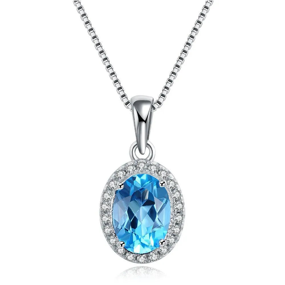 Four-piece 925 sterling silver jewellery set with blue topaz gemstones in a geometric design, showing earrings, ring, pendant and necklace.