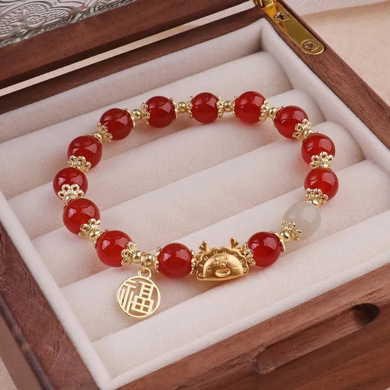 Women's floral glazed bracelet with ice crack texture and zodiac animal charm on wrist.
